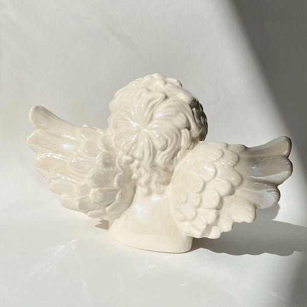 ceramic contemplating cherub figurine
