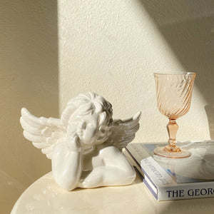 ceramic contemplating cherub figurine